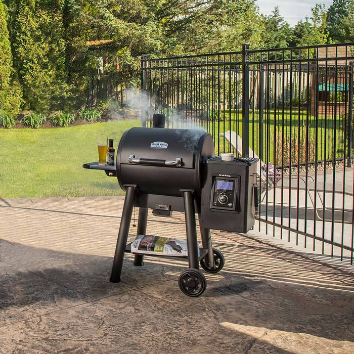 Broil King Crown Pellet 500 Smoker and Grill in open garden